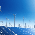 Wind and solar farm hybrid with panels in the foreground and windmills in the background